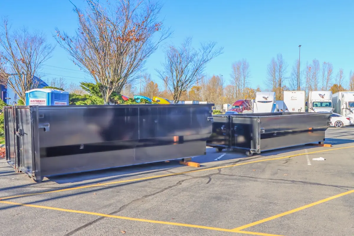 Professional dumpster rental service with roll-off container on residential driveway in West Salem